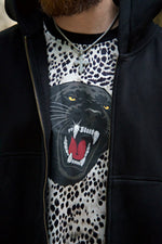 Black hoodie with a graphic of a panther on a leopard print background